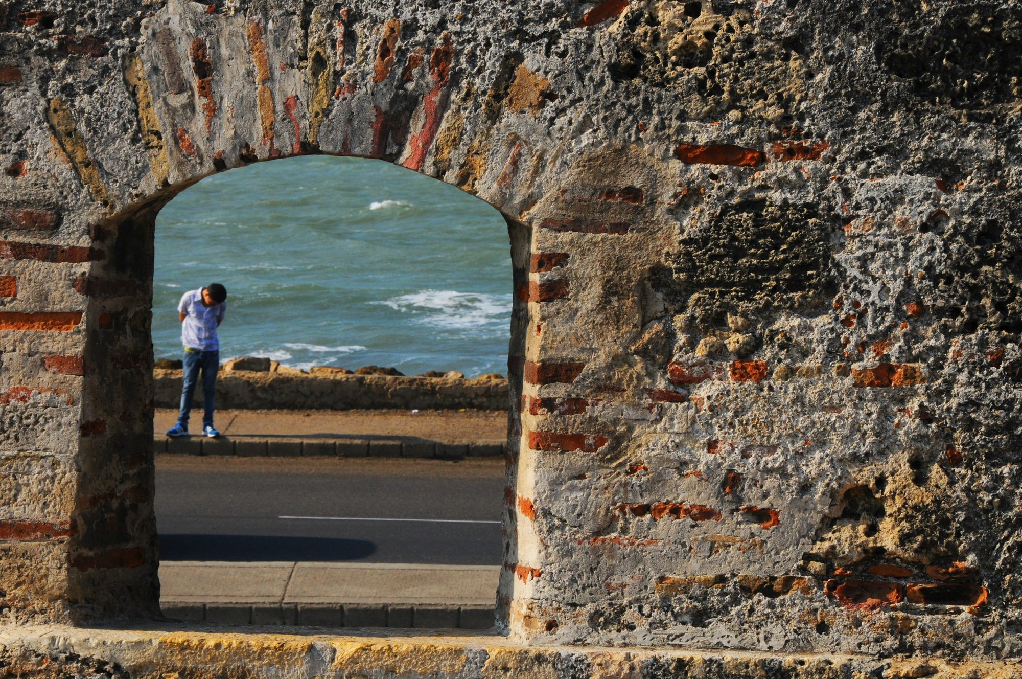 The seafront seen through an archway in the old stone city wall, Cartagena, Colombia — photograph by Brian Walker